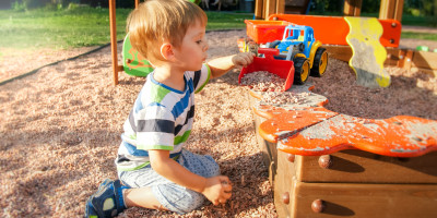 Child playing in a sandbox.