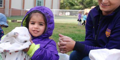 Child holding a blanket.