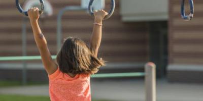 Child playing on monkey bars.
