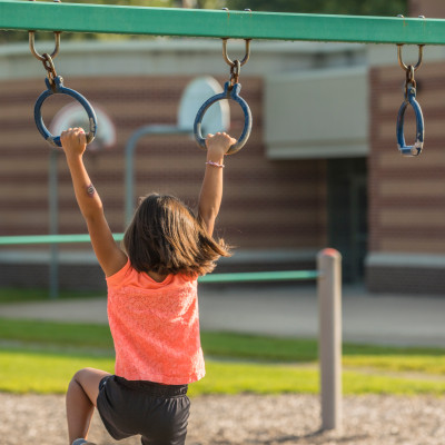 Child playing on monkey bars.